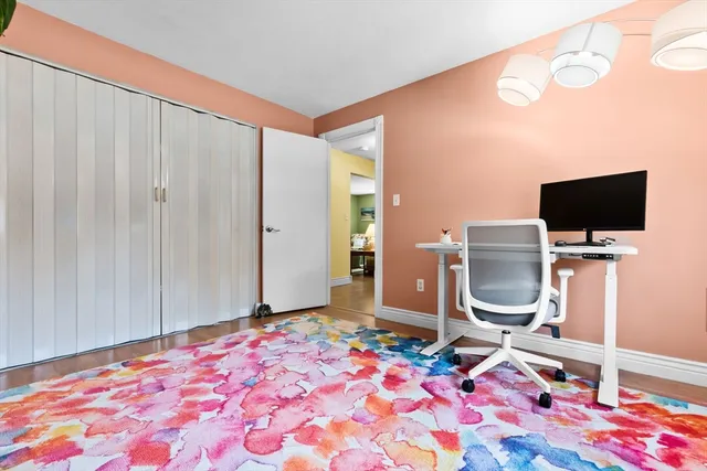 a bedroom with a bed and flat screen tv
