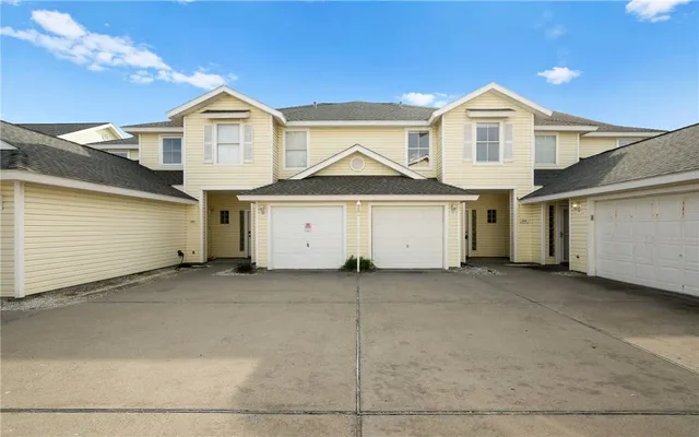 a view of a house with a yard and garage