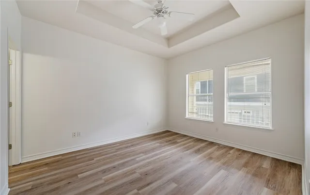 a view of a room with wooden floor
