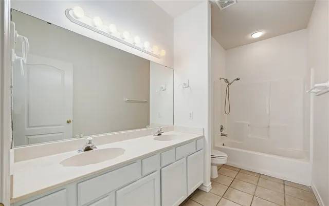 a bathroom with a sink a toilet and bathtub