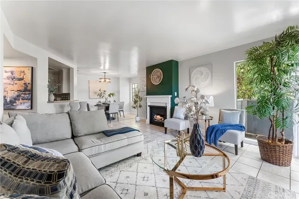 a living room with fireplace furniture and a large window