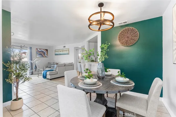 a view of a dining room with a table and chairs