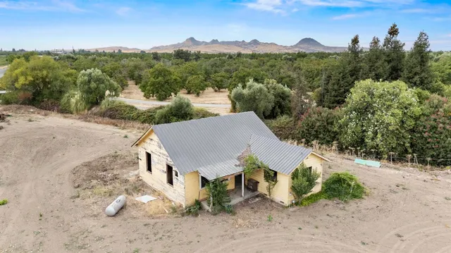 a view of a house with wooden fence
