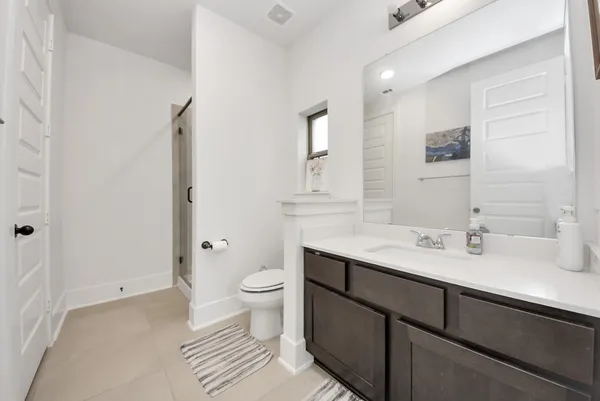 a bathroom with a double vanity sink mirror and shower
