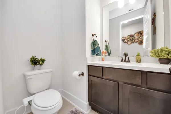 a living room with stainless steel appliances kitchen island granite countertop a sink and a refrigerator
