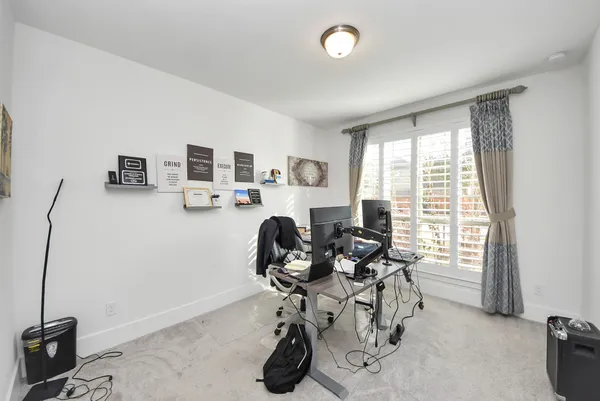 a living room with furniture a rug and white walls