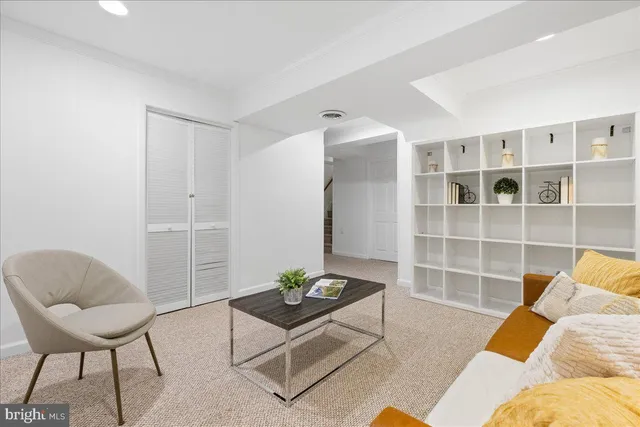 a living room with furniture and a rug