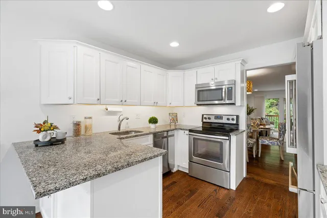 a kitchen with sink a stove and cabinets