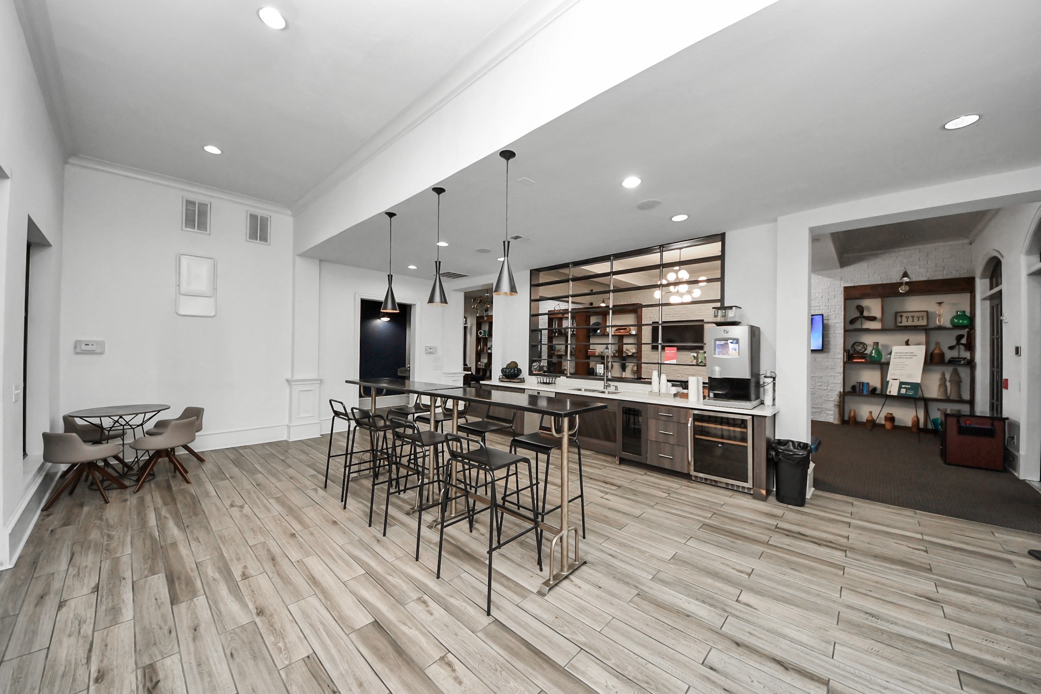 3003 Memorial Court, Unit 1139 Houston, TX 77007 - Photo 15 of 35 a kitchen with stainless steel appliances kitchen island granite countertop a stove top oven a chimney a dining table and chairs with wooden floor