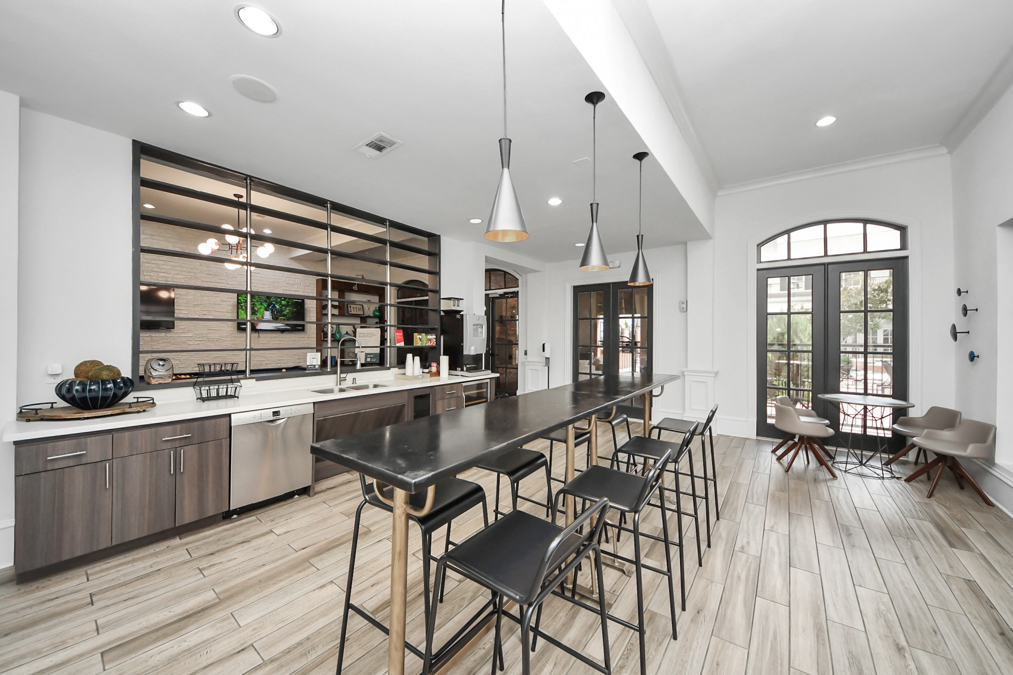3003 Memorial Court, Unit 1139 Houston, TX 77007 - Photo 19 of 35 a kitchen with stainless steel appliances granite countertop a stove top oven a sink dishwasher a dining table and chairs with wooden floor