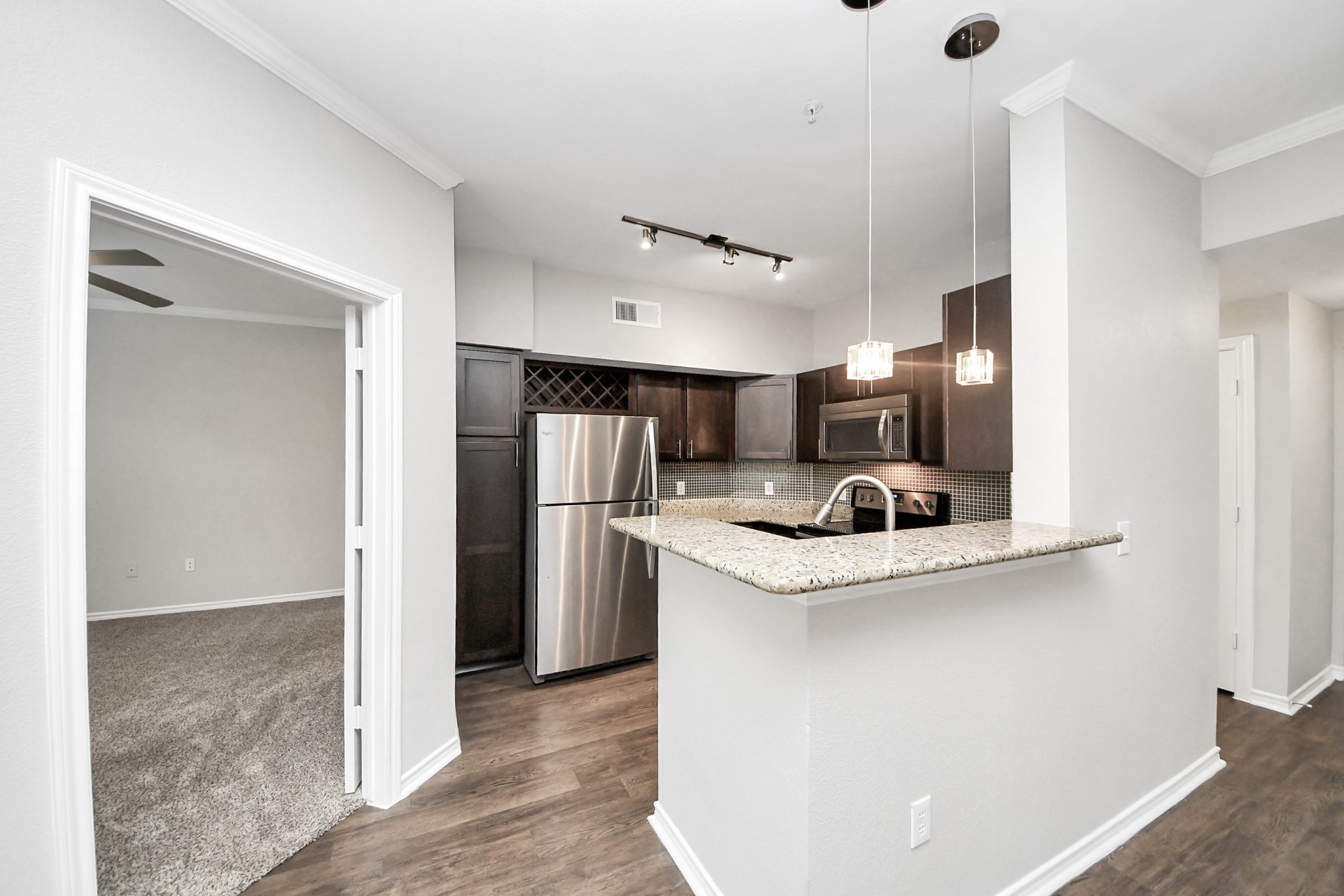 3003 Memorial Court, Unit 1139 Houston, TX 77007 - Photo 25 of 35 a kitchen with stainless steel appliances granite countertop a sink stove and refrigerator