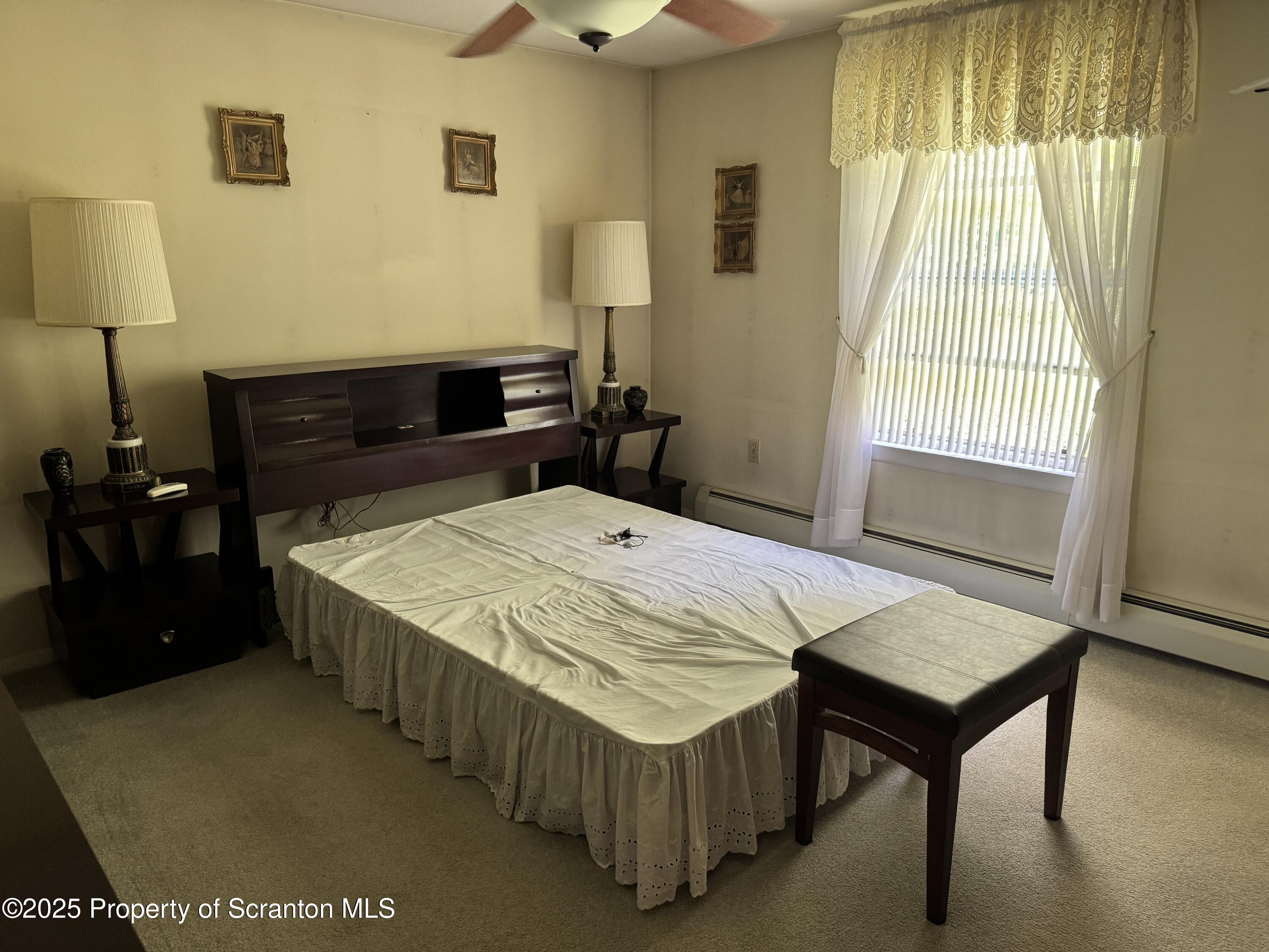 2356 Newton Ransom Boulevard Clarks Summit, PA 18411 - Photo 13 of 30 a bed sitting in a bedroom next to a window