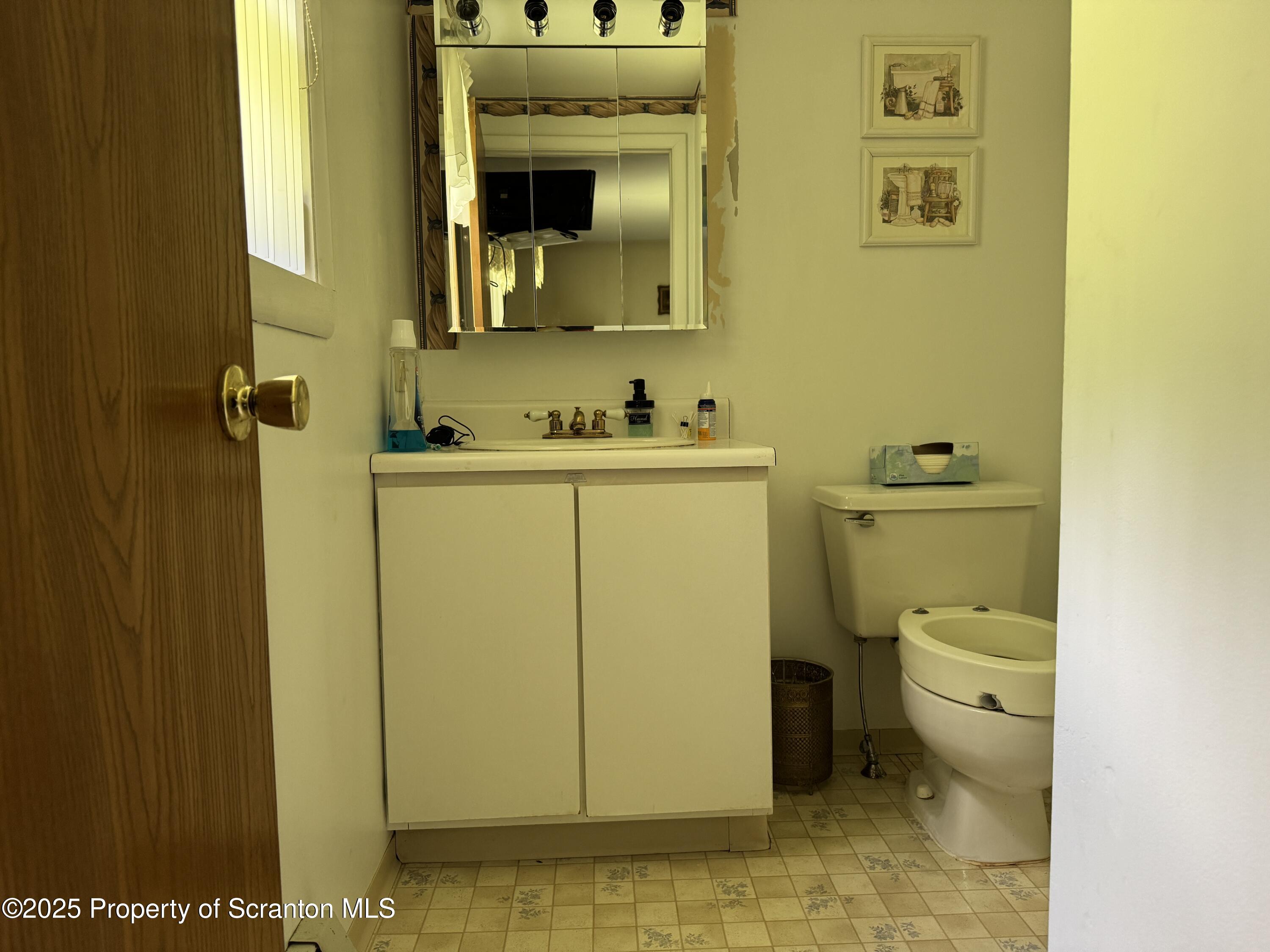 2356 Newton Ransom Boulevard Clarks Summit, PA 18411 - Photo 14 of 30 a bathroom with a toilet sink and mirror