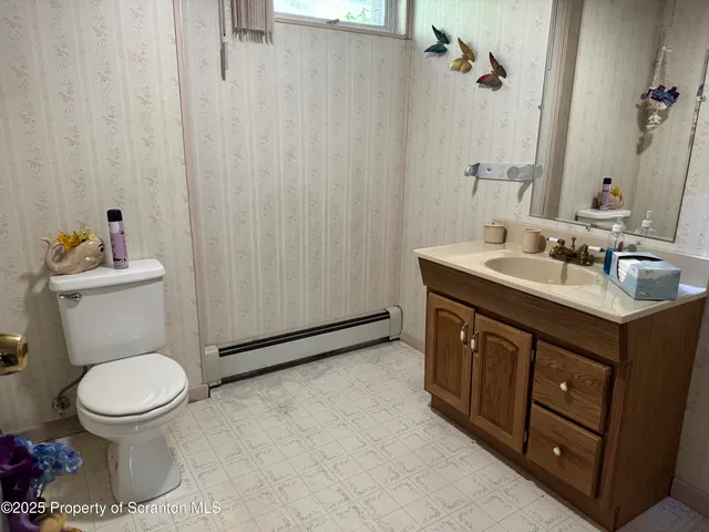 a bed room with furniture and a flat screen tv