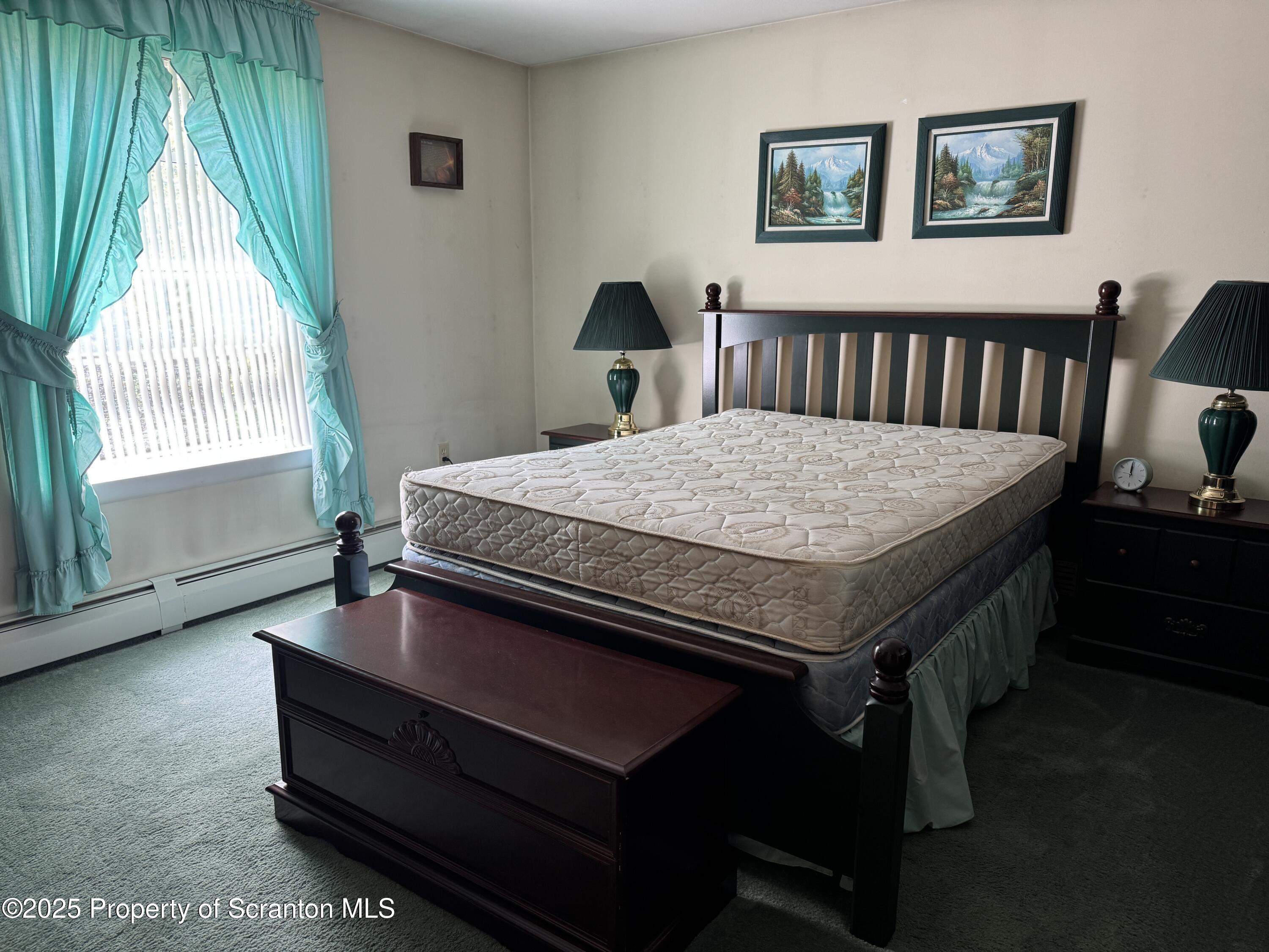 2356 Newton Ransom Boulevard Clarks Summit, PA 18411 - Photo 10 of 30 a bed sitting in a bedroom next to a window