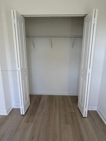 a white toilet sitting next to a bath tub