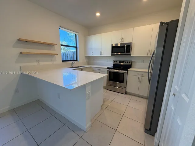 a kitchen with a sink stove and refrigerator