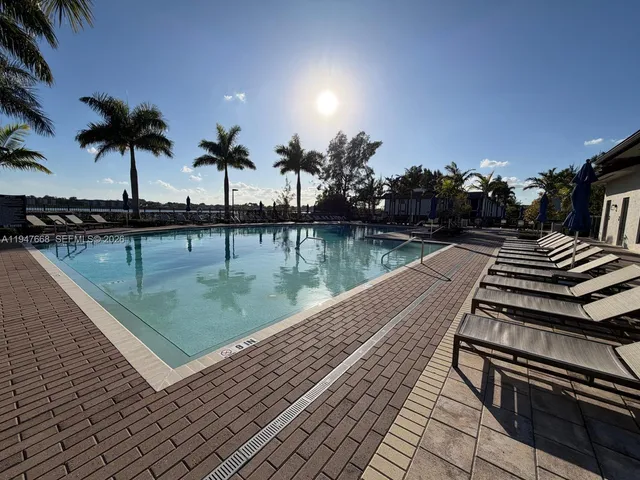 a view of a swimming pool with a table and chairs