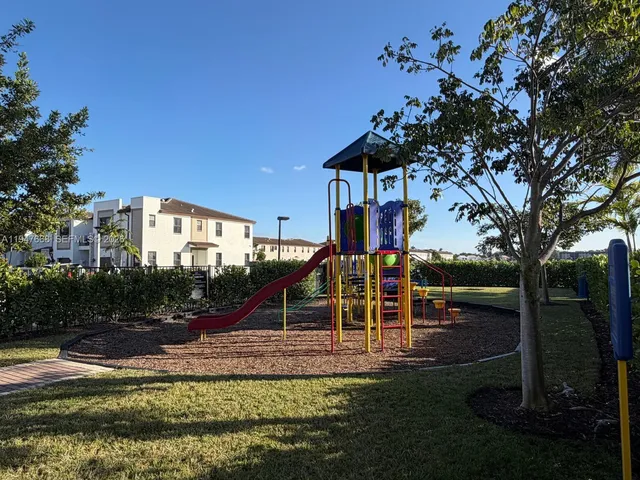 a view of a living room and livingroom with furniture wooden floor a ceiling fan and a rug
