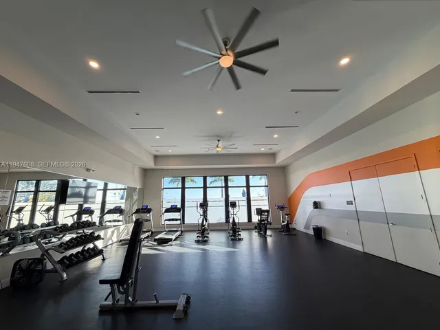 a kitchen with stainless steel appliances kitchen island granite countertop a table and chairs