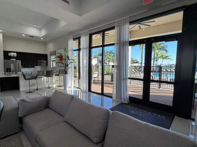 a living room with furniture a rug and white walls