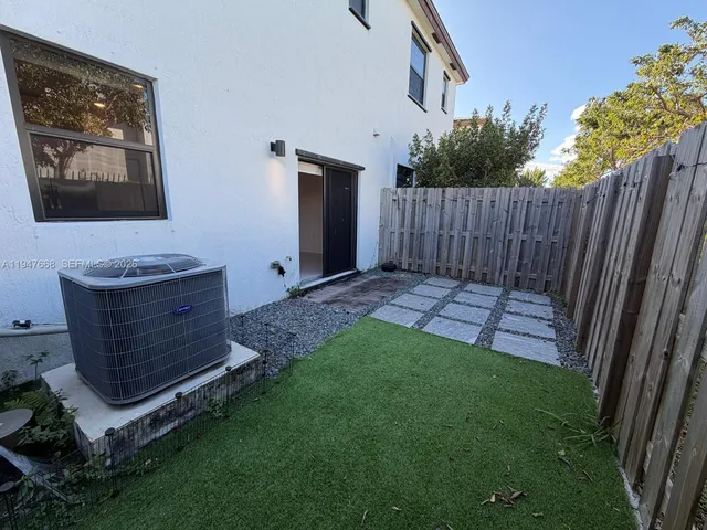a view of backyard with a garden and stairs