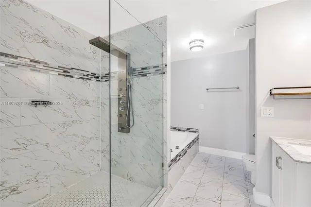 a bathroom with a shower and a sink