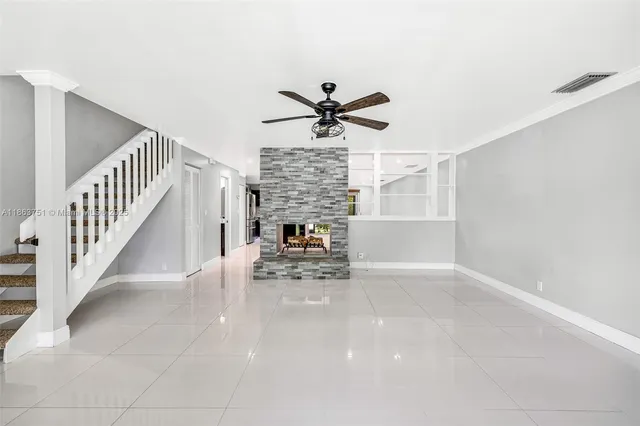 a view of entryway and hall with a ceiling fan