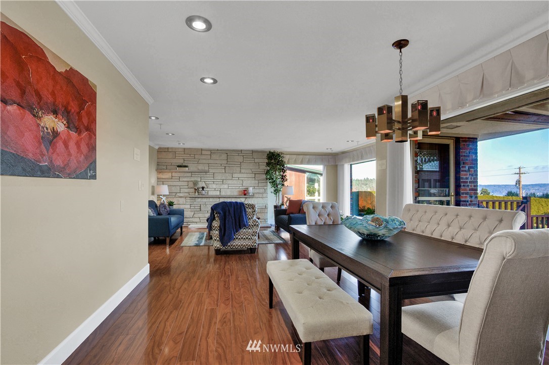 7002 Soundview Drive Gig Harbor, WA 98335 - Photo 11 of 33 a view of a dining room with furniture window and wooden floor