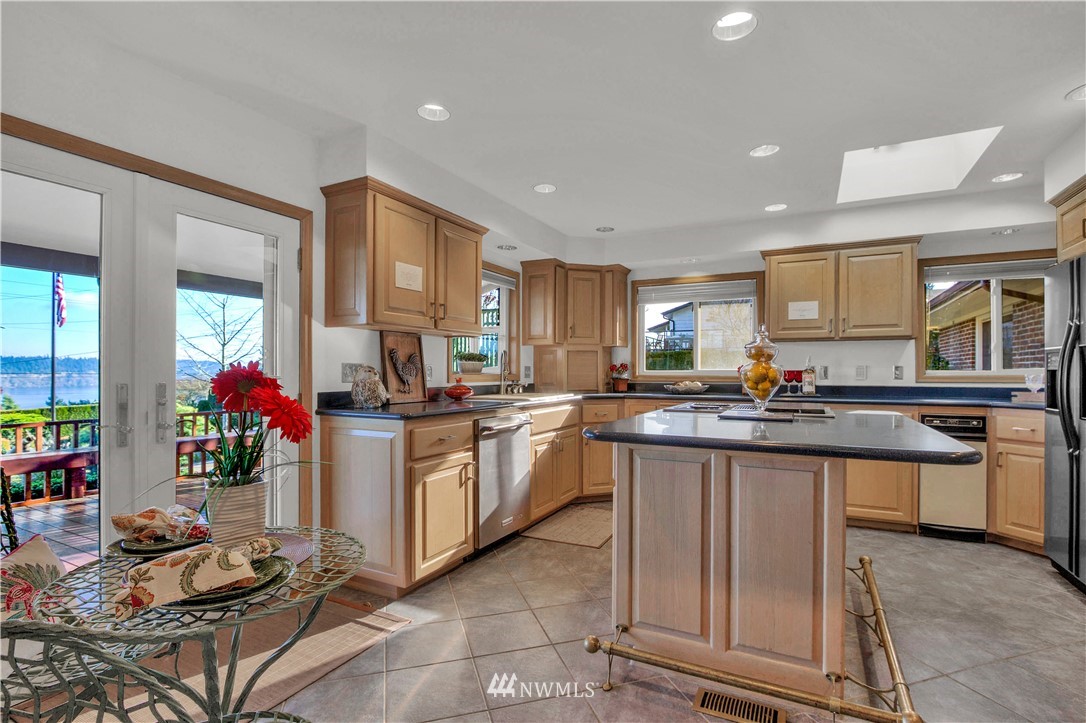 7002 Soundview Drive Gig Harbor, WA 98335 - Photo 13 of 33 a kitchen with sink refrigerator and cabinets