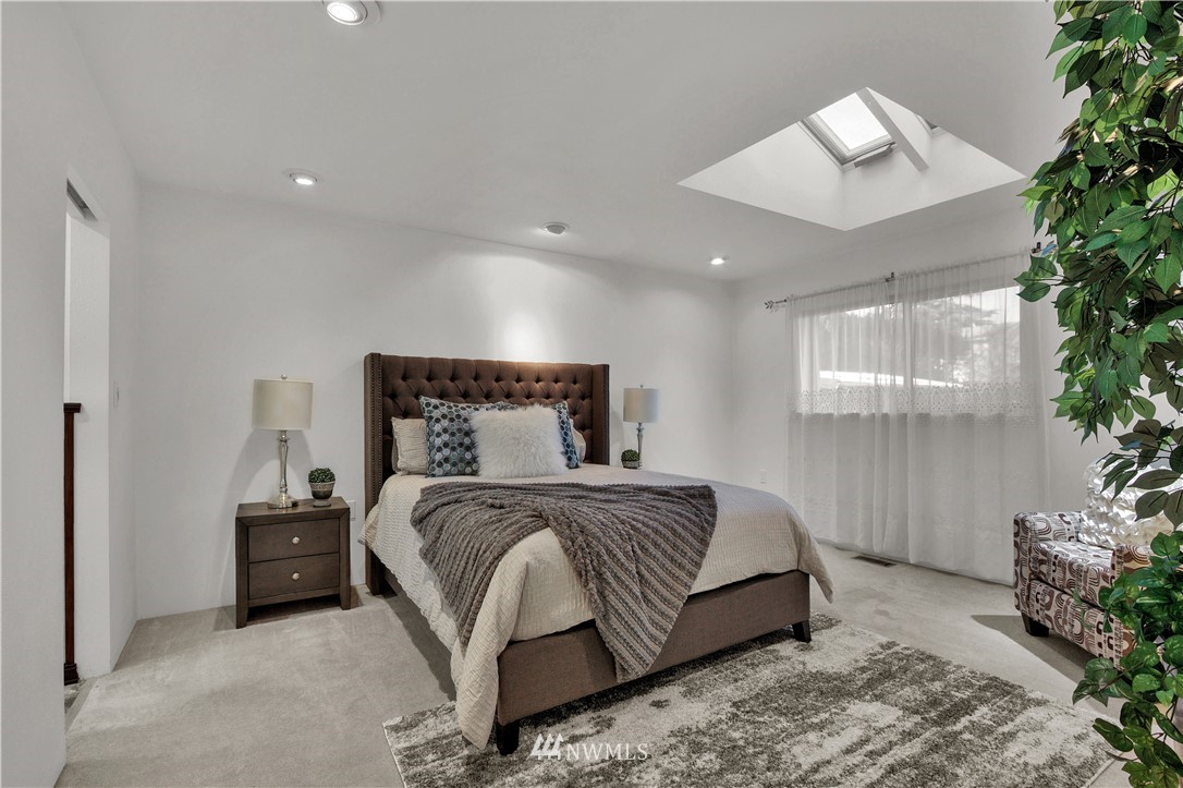 7002 Soundview Drive Gig Harbor, WA 98335 - Photo 16 of 33 a bedroom with a bed and a potted plant