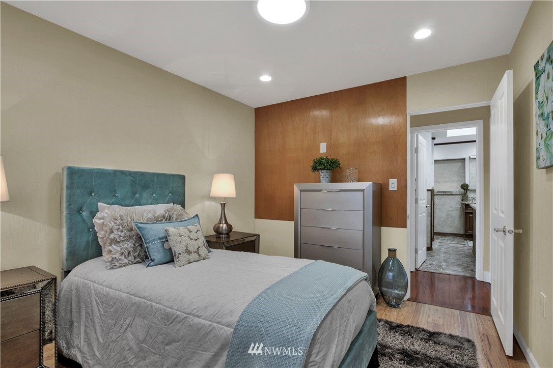 7002 Soundview Drive Gig Harbor, WA 98335 - Photo 20 of 33 a bedroom with a bed and wooden floor