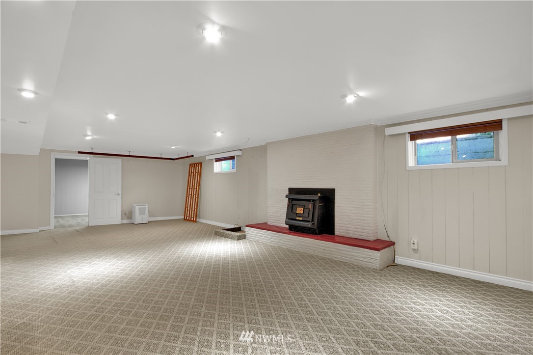7002 Soundview Drive Gig Harbor, WA 98335 - Photo 23 of 33 an empty room with fireplace and windows