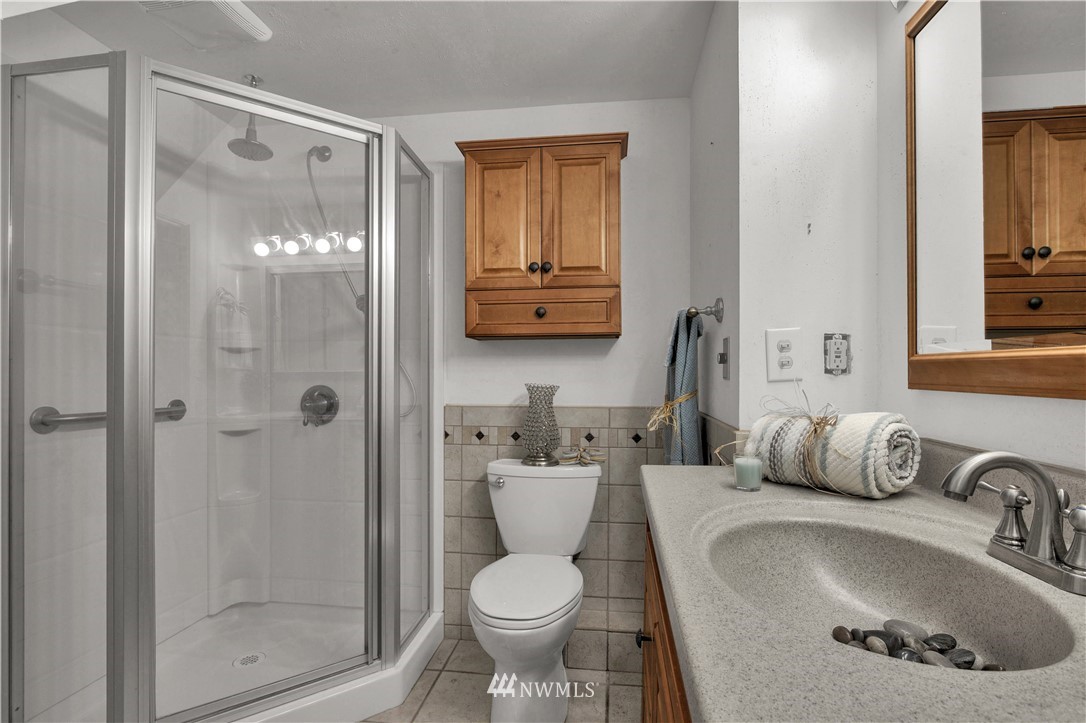7002 Soundview Drive Gig Harbor, WA 98335 - Photo 27 of 33 a bathroom with a sink toilet and shower