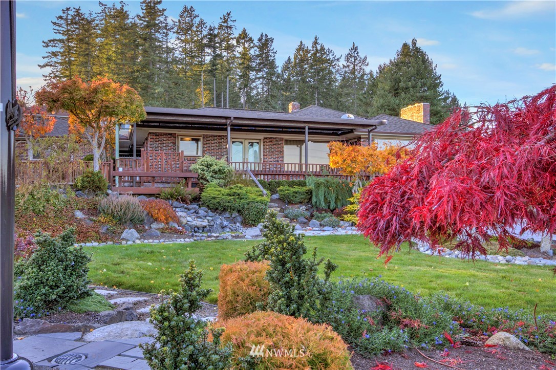 7002 Soundview Drive Gig Harbor, WA 98335 - Photo 7 of 33 a view of a house with a big yard and large trees