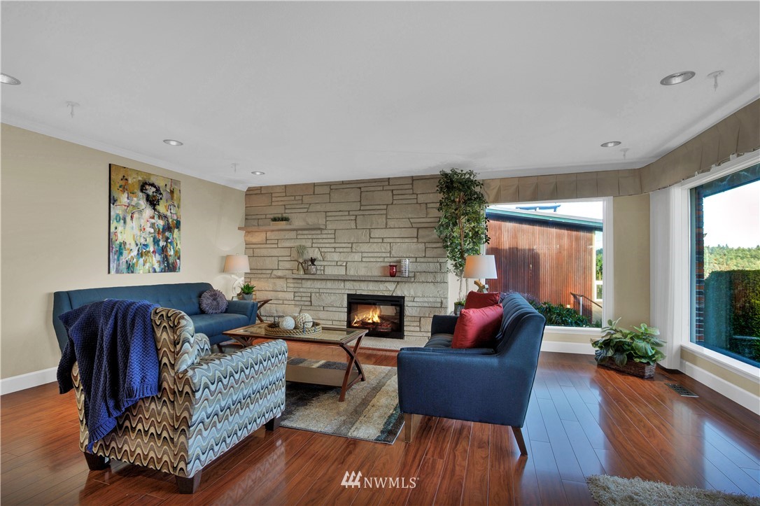 7002 Soundview Drive Gig Harbor, WA 98335 - Photo 10 of 33 a living room with furniture fireplace and potted plants