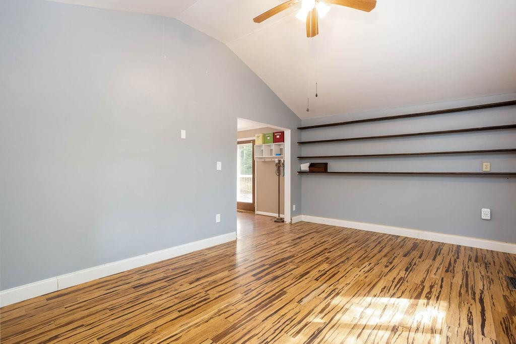 307 South King Charles Road Raleigh, NC 27610 - Photo 12 of 32 a view of an empty room with wooden floor