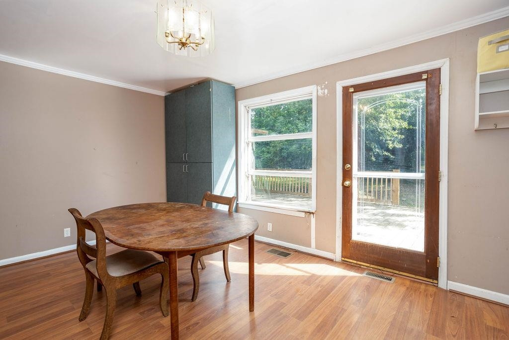 307 South King Charles Road Raleigh, NC 27610 - Photo 10 of 32 a view of a dining room with furniture window and wooden floor