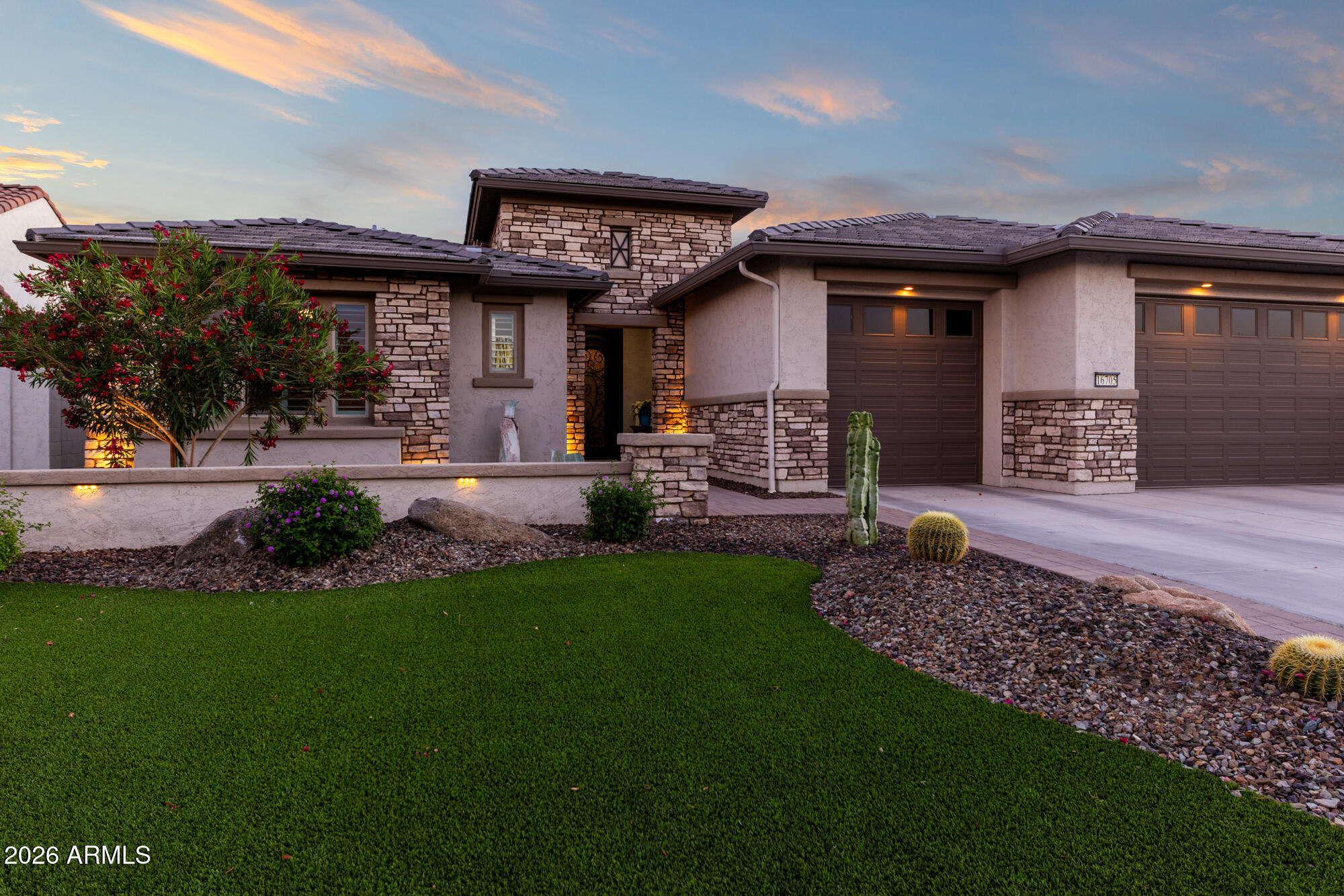16705 Virginia Avenue Goodyear, AZ 85395 - Photo 1 of 56 a front view of a house with a garden and patio
