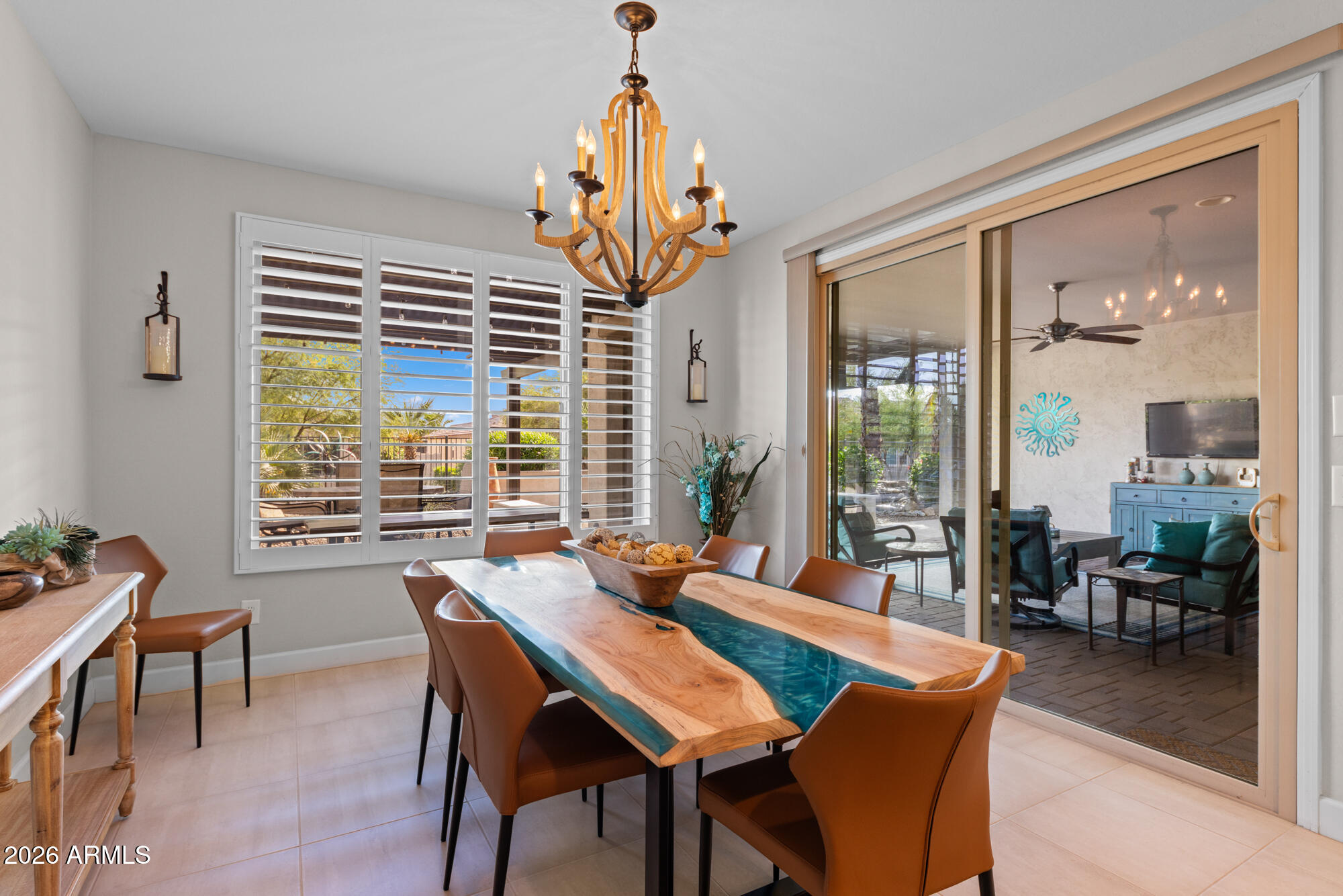 16705 Virginia Avenue Goodyear, AZ 85395 - Photo 20 of 56 a dining room with furniture a chandelier and wooden floor