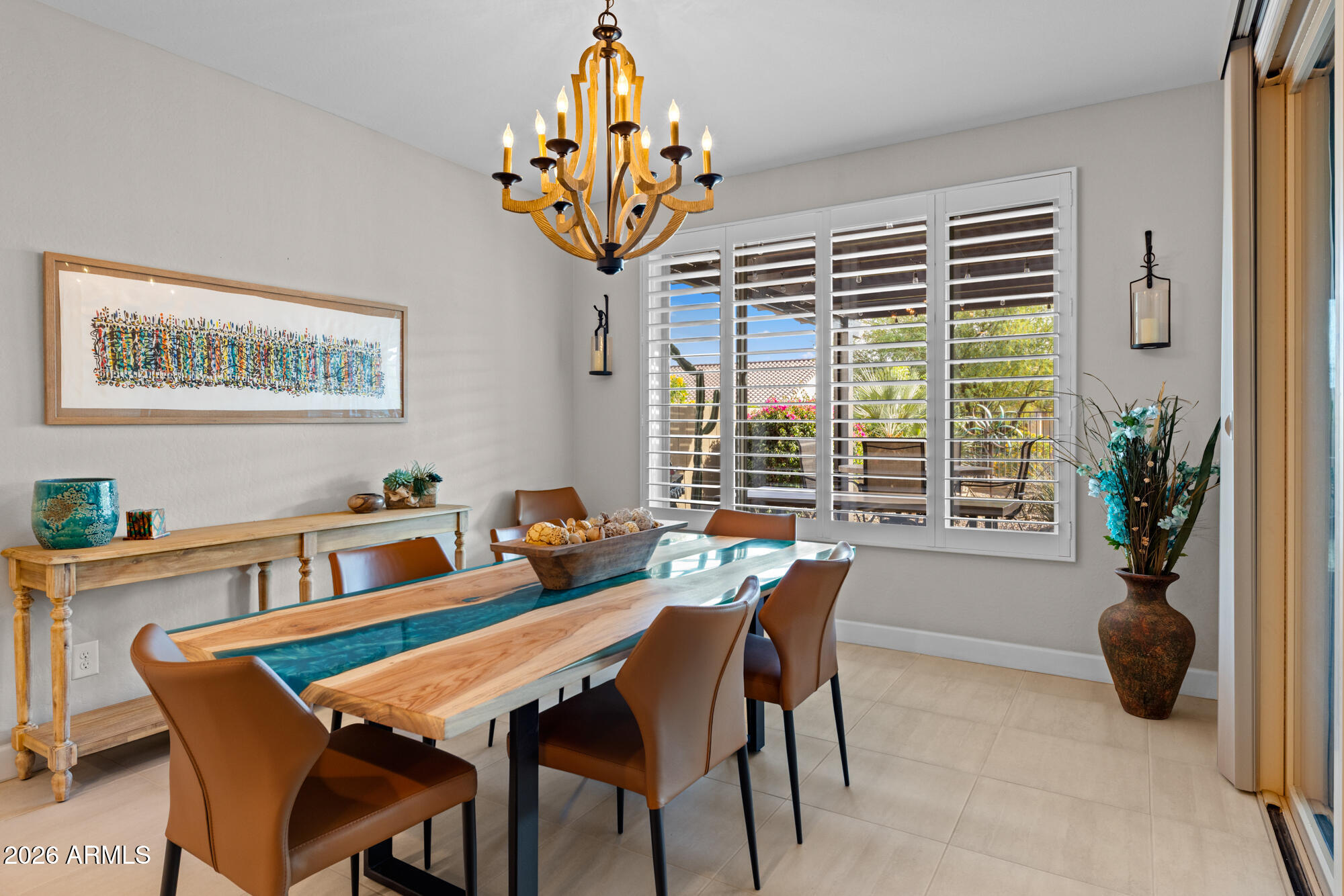 16705 Virginia Avenue Goodyear, AZ 85395 - Photo 21 of 56 a view of a dining room and livingroom with furniture wooden floor and a chandelier