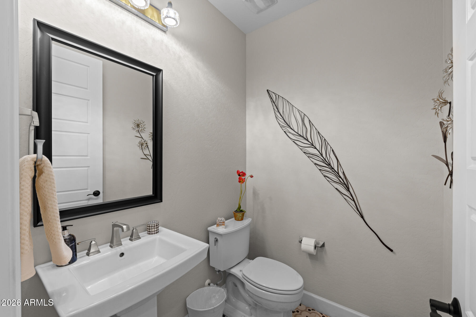 16705 Virginia Avenue Goodyear, AZ 85395 - Photo 26 of 56 a bathroom with a sink mirror vanity and toilet