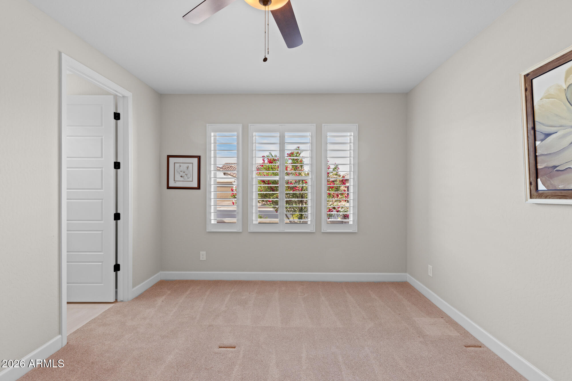 16705 Virginia Avenue Goodyear, AZ 85395 - Photo 28 of 56 wooden floor in an empty room with a window