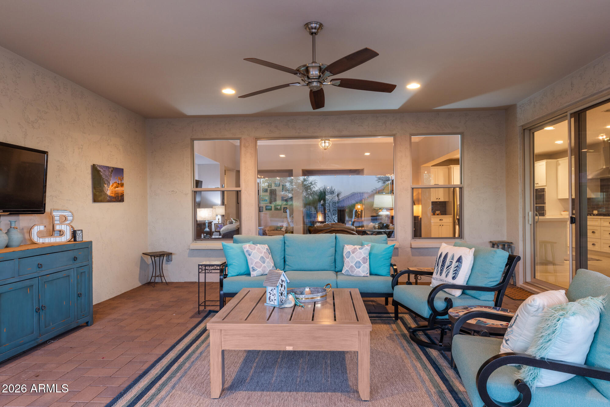 16705 Virginia Avenue Goodyear, AZ 85395 - Photo 33 of 56 a living room with furniture and a flat screen tv