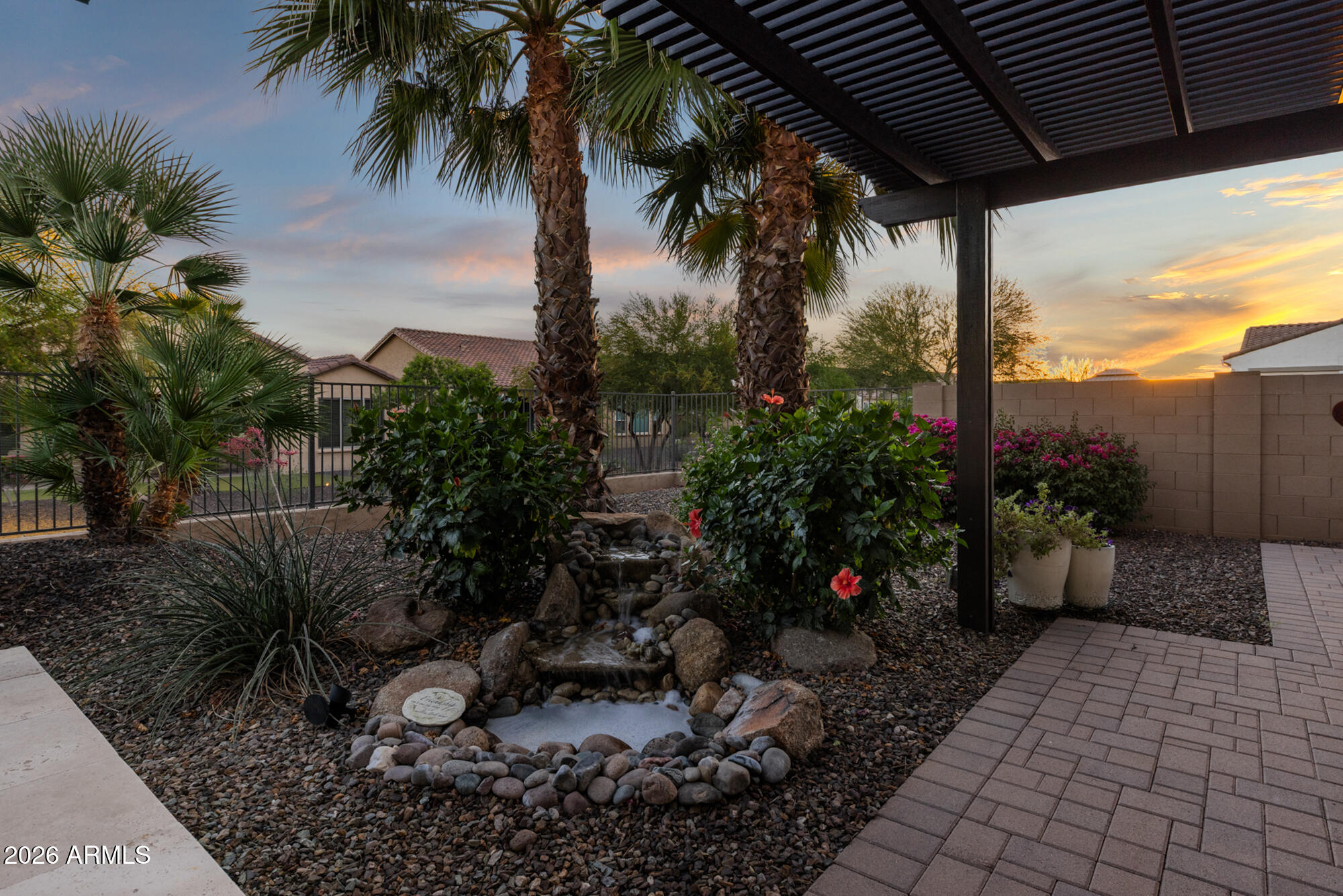16705 Virginia Avenue Goodyear, AZ 85395 - Photo 43 of 56 a couple of flower plants in front of yellow house