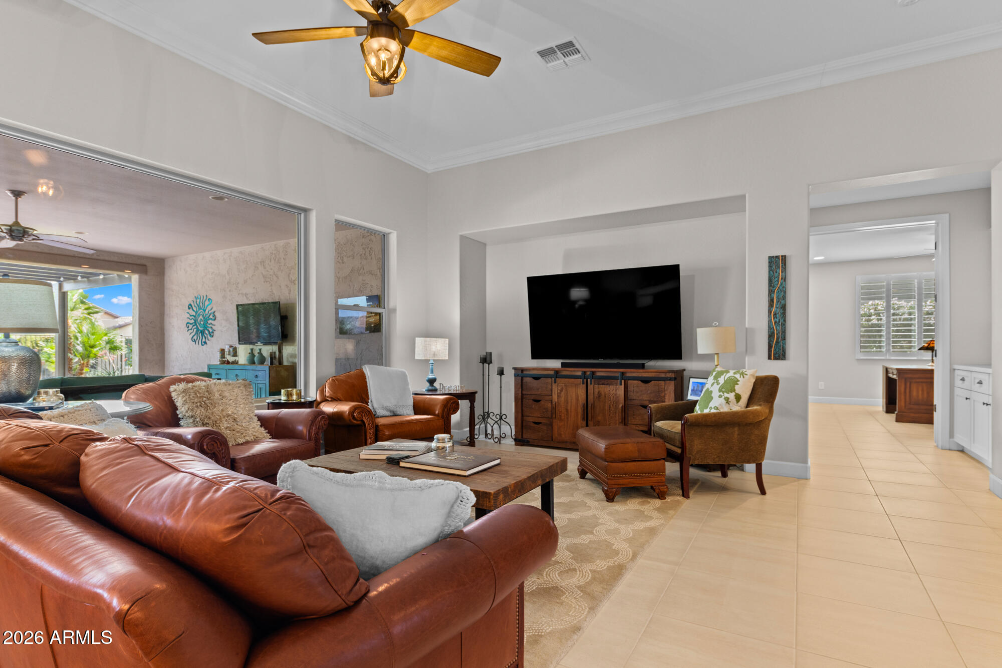 16705 Virginia Avenue Goodyear, AZ 85395 - Photo 8 of 56 a living room with furniture and a flat screen tv