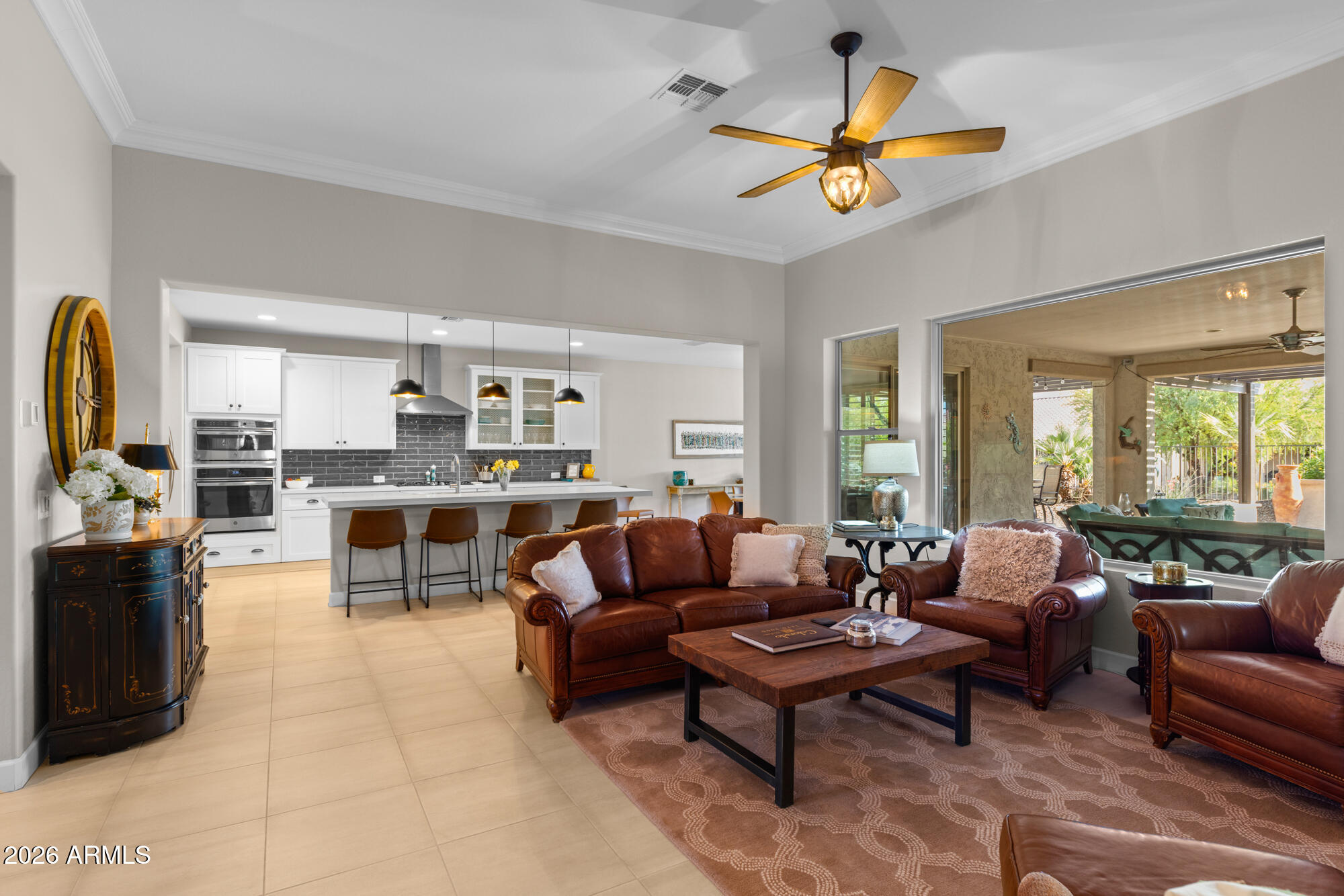 16705 Virginia Avenue Goodyear, AZ 85395 - Photo 9 of 56 a living room with furniture kitchen view and a large window