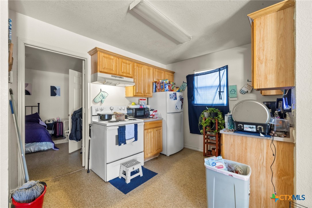 120 South 23rd Street Temple, TX 76504 - Photo 7 of 12 a kitchen with a refrigerator and a stove