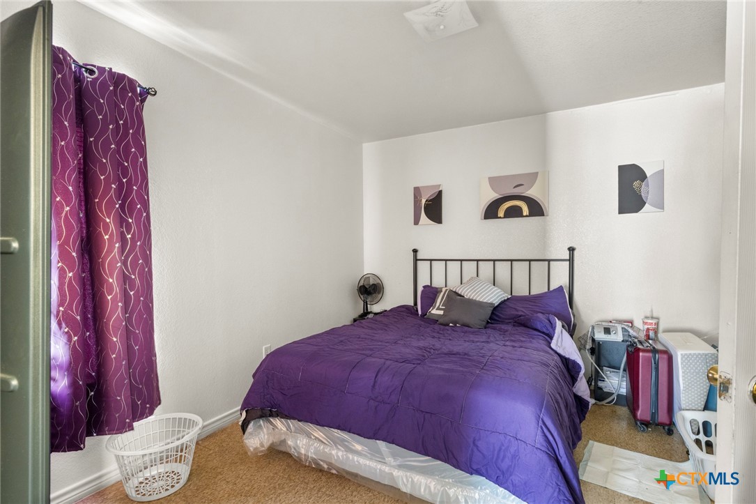 120 South 23rd Street Temple, TX 76504 - Photo 8 of 12 a bedroom with a bed and a painting on the wall
