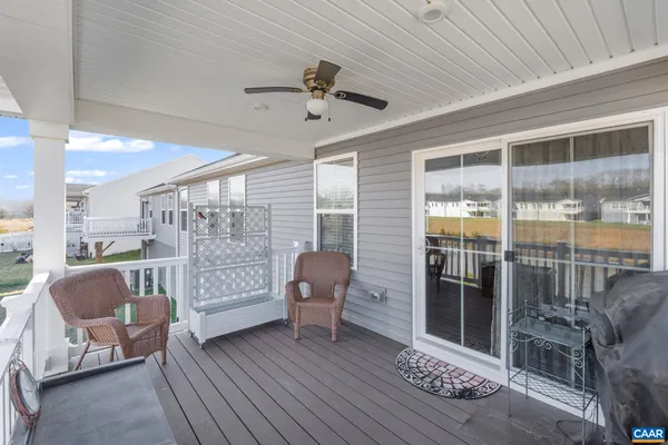 a view of a house with a big yard and large trees